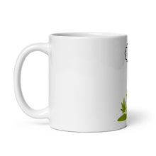 Load image into Gallery viewer, Left side of white glossy mug with plant design 